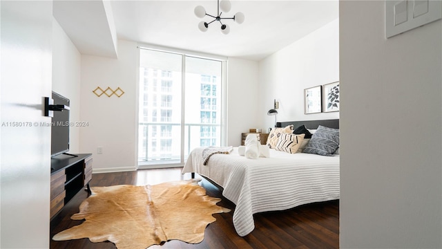 bedroom with dark hardwood / wood-style flooring and a chandelier