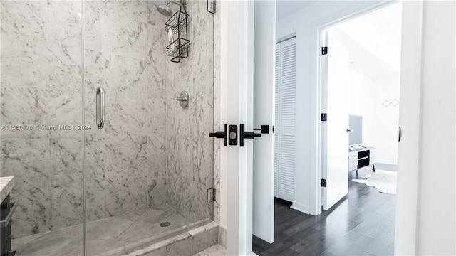 bathroom featuring wood-type flooring, vanity, and walk in shower