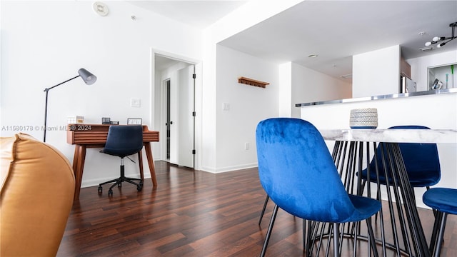 interior space featuring rail lighting and dark hardwood / wood-style floors