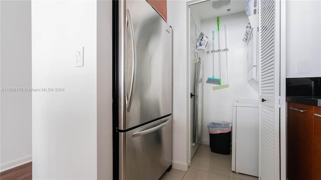 kitchen with stainless steel fridge and light tile flooring