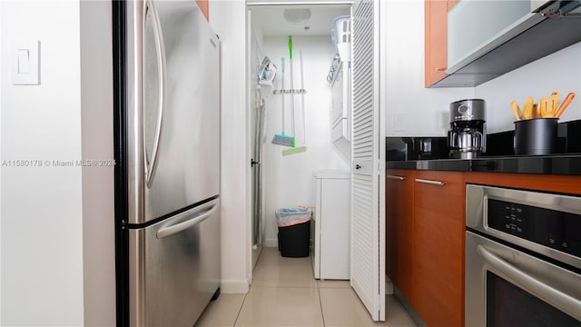 kitchen featuring light tile flooring and stainless steel appliances