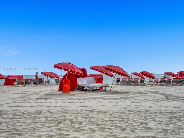 exterior space with a water view and a view of the beach