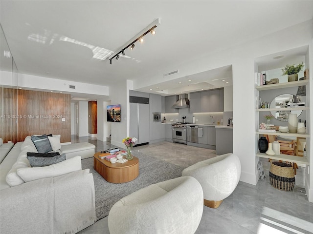 living room with track lighting and sink