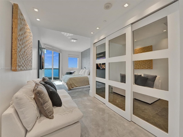 bedroom with french doors, access to outside, and a water view