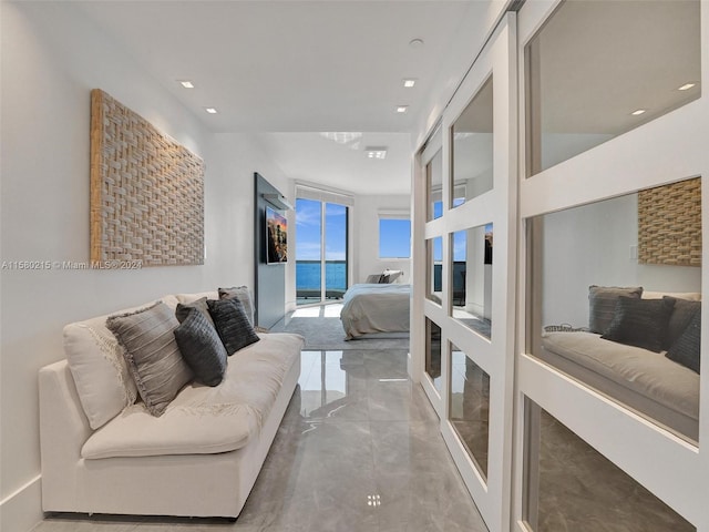 tiled living room featuring a water view