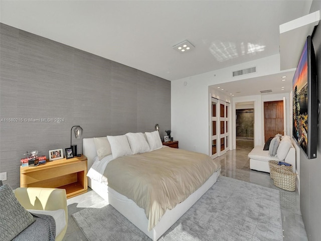 bedroom with a closet and concrete flooring