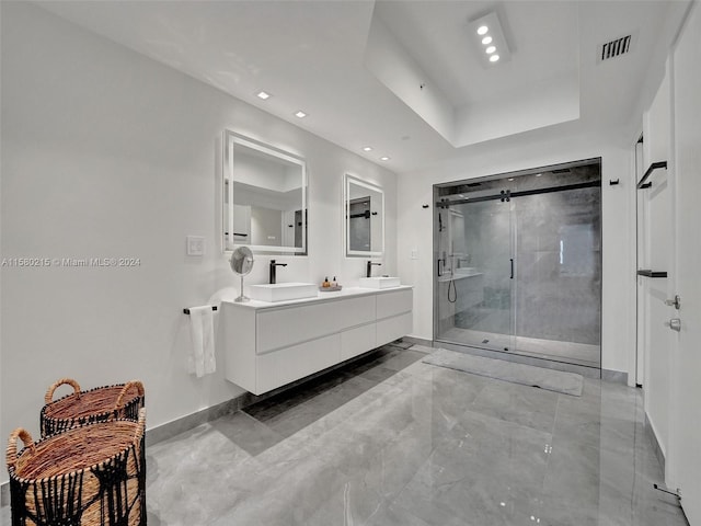 bathroom with an enclosed shower, tile floors, dual vanity, and a raised ceiling