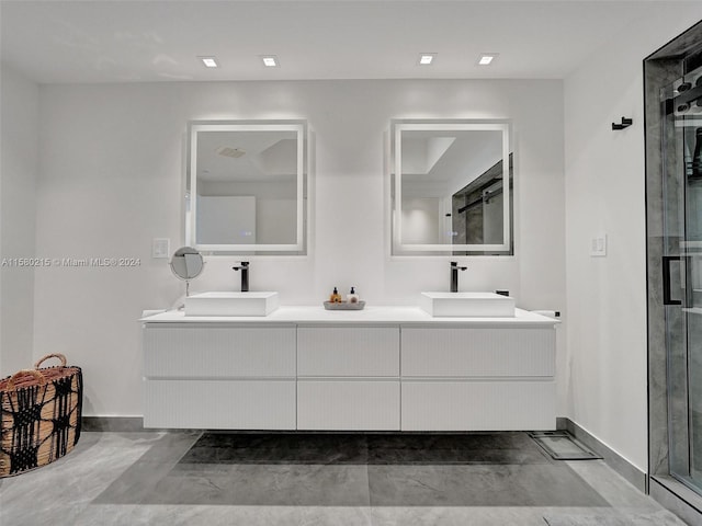 bathroom with a shower with door and double vanity