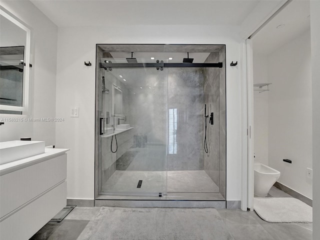 bathroom with walk in shower, vanity, and tile floors