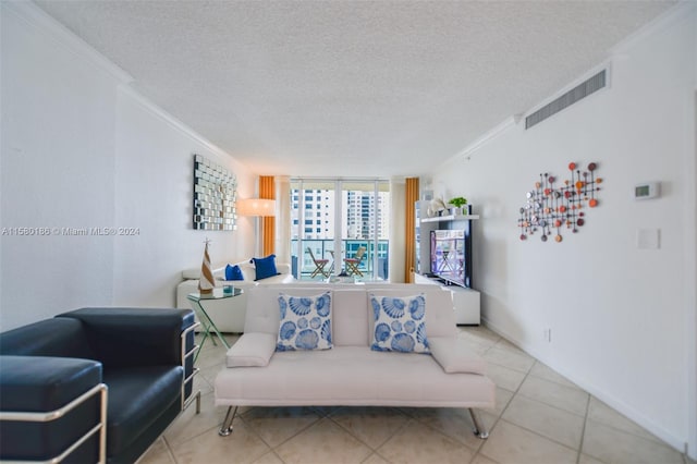 tiled living room with a textured ceiling, expansive windows, and ornamental molding