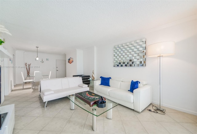 tiled living room featuring a textured ceiling