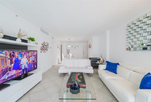 living room with crown molding, a textured ceiling, and light tile flooring