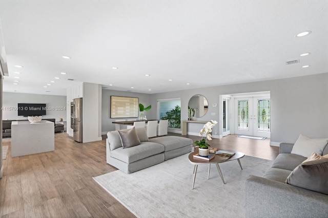 living room with light hardwood / wood-style floors and french doors