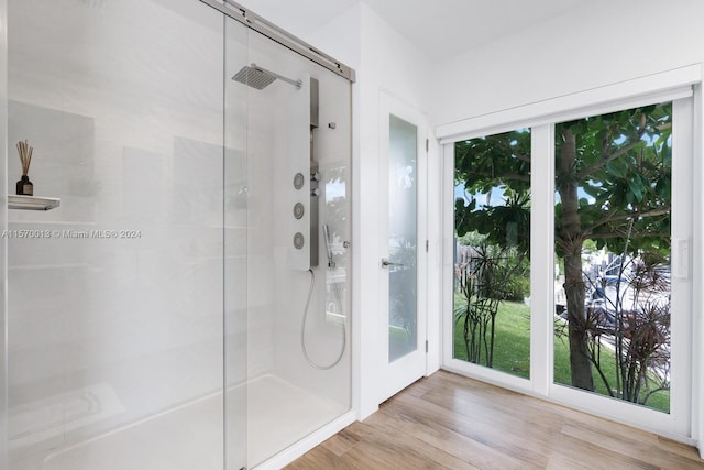 bathroom with wood-type flooring and walk in shower