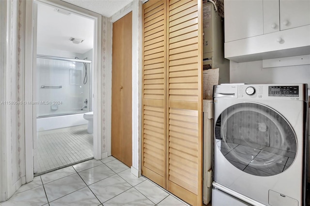 laundry area with washer / dryer and light tile patterned floors