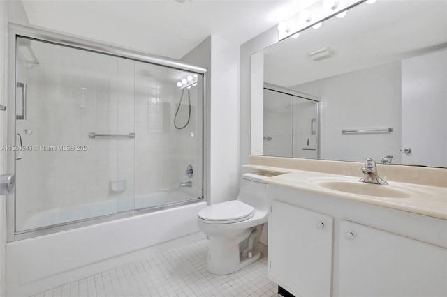 full bathroom with toilet, shower / bath combination with glass door, tile patterned flooring, and vanity