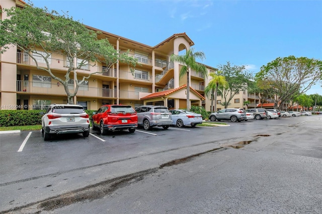 view of building exterior with uncovered parking