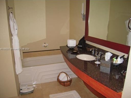 bathroom with tile flooring and sink