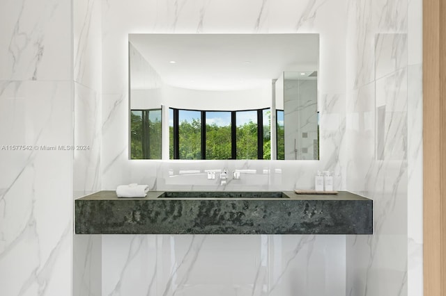 bathroom with tile walls and sink