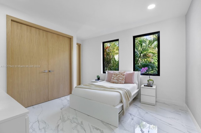 tiled bedroom with a closet