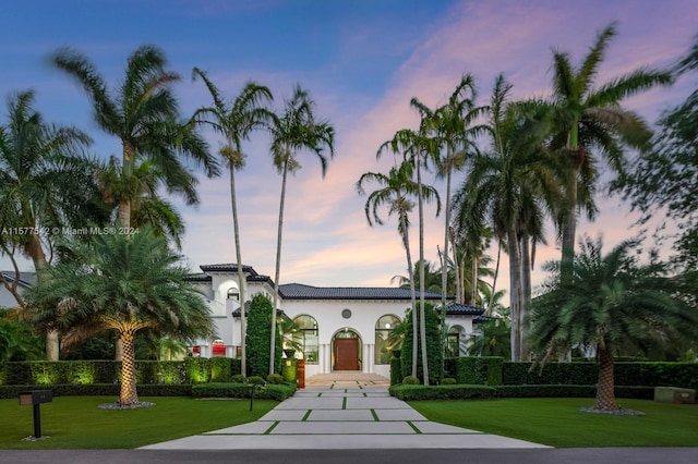 mediterranean / spanish home with a yard