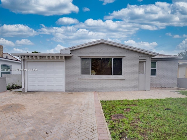 single story home with a front lawn and a garage