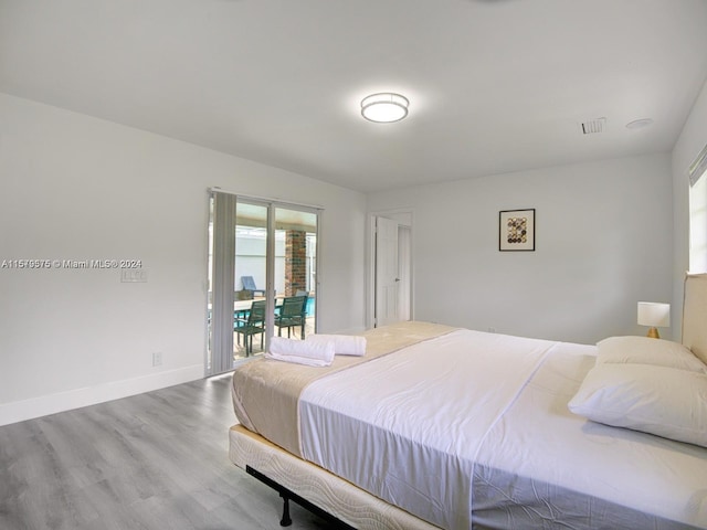 bedroom featuring hardwood / wood-style floors and access to exterior