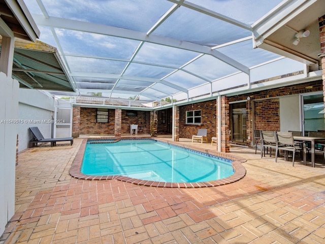 view of pool featuring a lanai and a patio