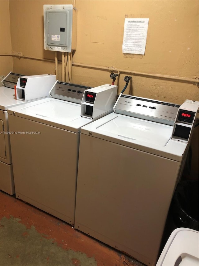 clothes washing area featuring separate washer and dryer and electric panel