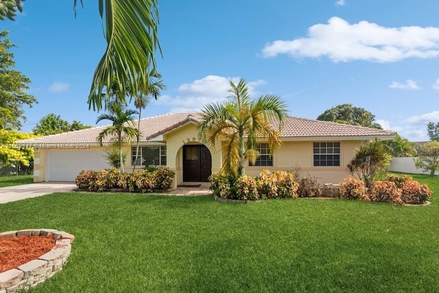 view of front of property featuring a front yard and a garage