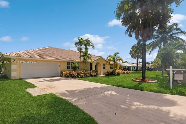 view of front of home with a garage and a front yard