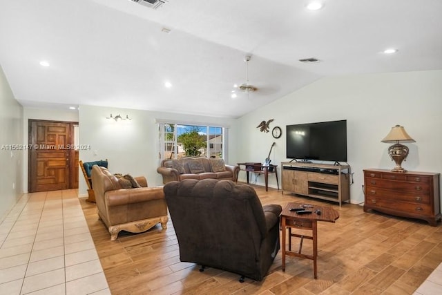 living room with light hardwood / wood-style flooring and vaulted ceiling