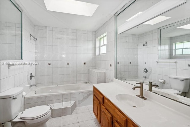 full bathroom featuring a healthy amount of sunlight, tile walls, tile flooring, a skylight, and toilet