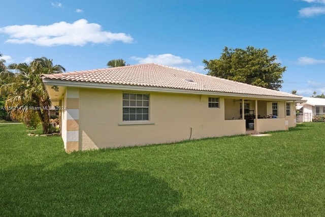 rear view of property featuring a yard