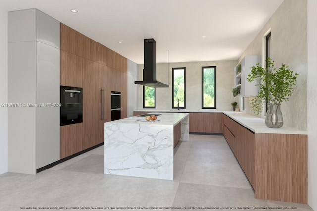 kitchen featuring range hood, light stone countertops, and a center island