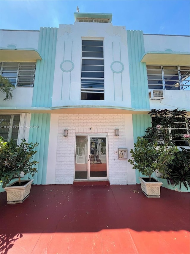 entrance to property with a wall mounted air conditioner