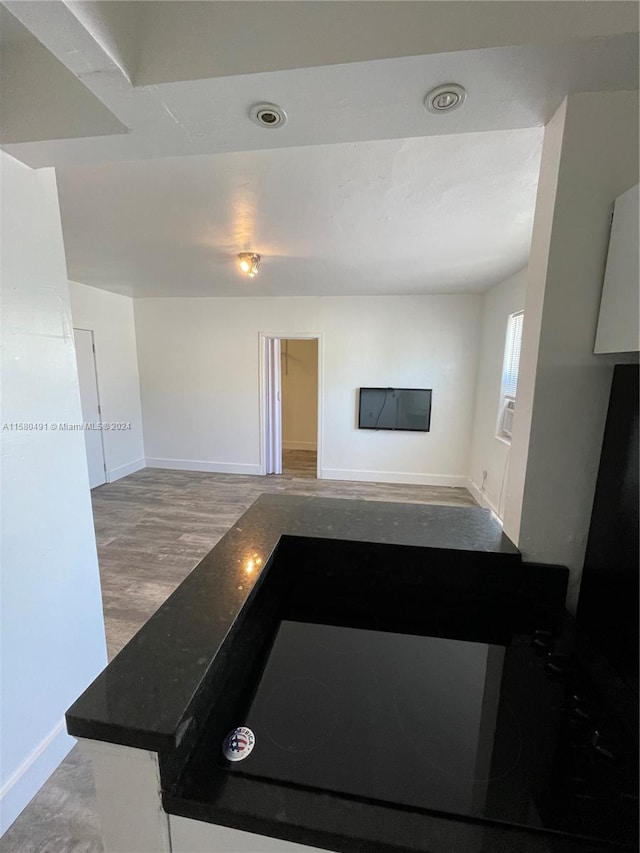 kitchen featuring hardwood / wood-style floors and white cabinets