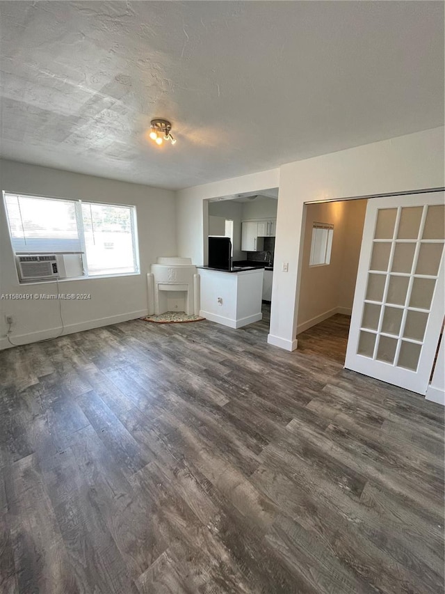 unfurnished living room with dark hardwood / wood-style floors