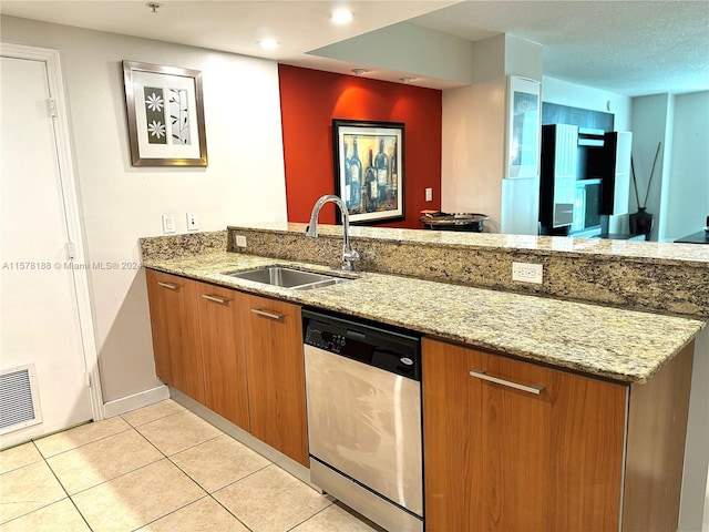 kitchen featuring dishwasher, light tile floors, sink, and light stone countertops