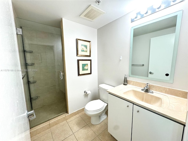 bathroom featuring tile floors, vanity, an enclosed shower, and toilet