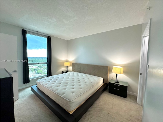 carpeted bedroom featuring a textured ceiling