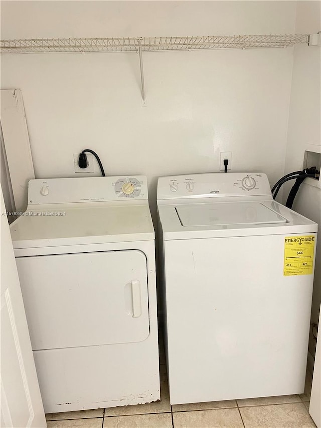 laundry room with hookup for a washing machine, hookup for an electric dryer, light tile floors, and washer and dryer