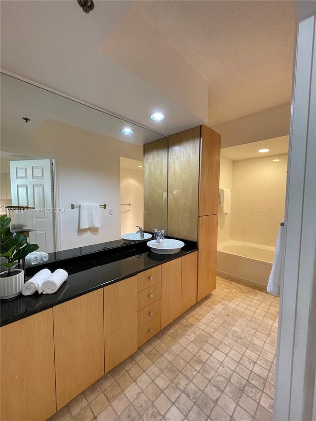 bathroom with shower / bathtub combination, dual vanity, tile floors, and a textured ceiling