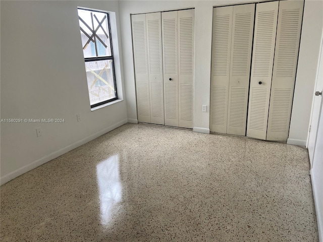 unfurnished bedroom with multiple closets