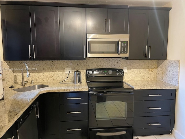 kitchen featuring backsplash, black electric range oven, dishwashing machine, and sink