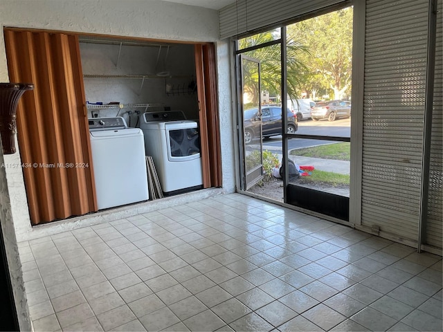 laundry area featuring tile flooring, washer hookup, and separate washer and dryer