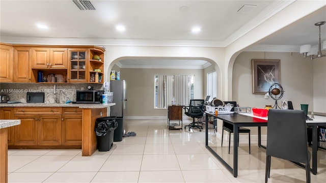 kitchen featuring backsplash, appliances with stainless steel finishes, light tile flooring, and light stone counters