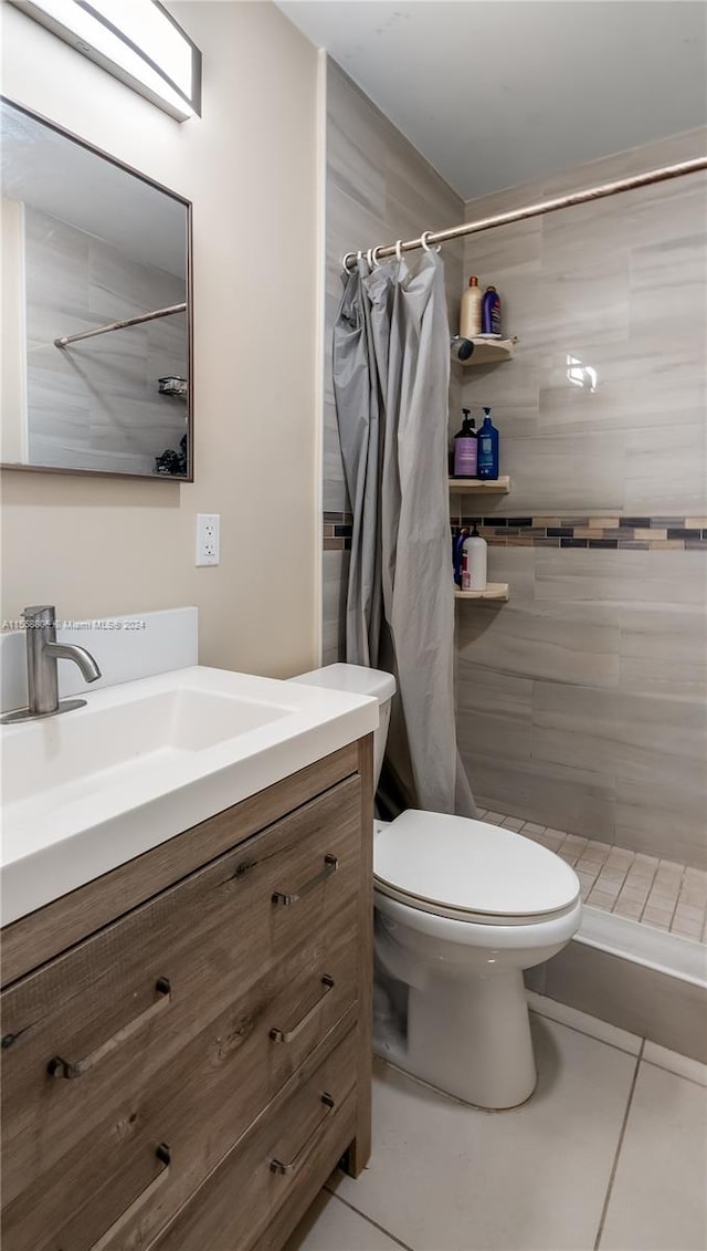 bathroom featuring tile flooring, oversized vanity, curtained shower, and toilet