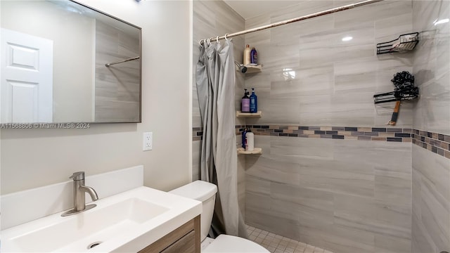 bathroom featuring a shower with shower curtain, vanity, and toilet