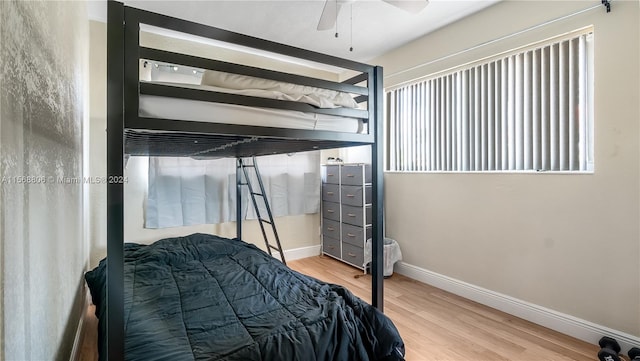 bedroom with light hardwood / wood-style floors and ceiling fan